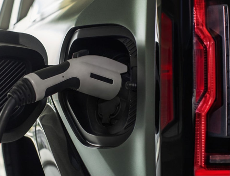Close up of charging port with charger plugged in on a GMC Hummer EV SUV - Neessen GMC in Kingsville TX